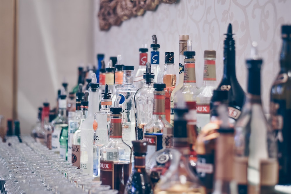 Selection of spirits behind a bar - Photo by Ibrahim Boran on Unsplash